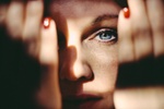 Close portrait of a beautiful woman with blue eyes.